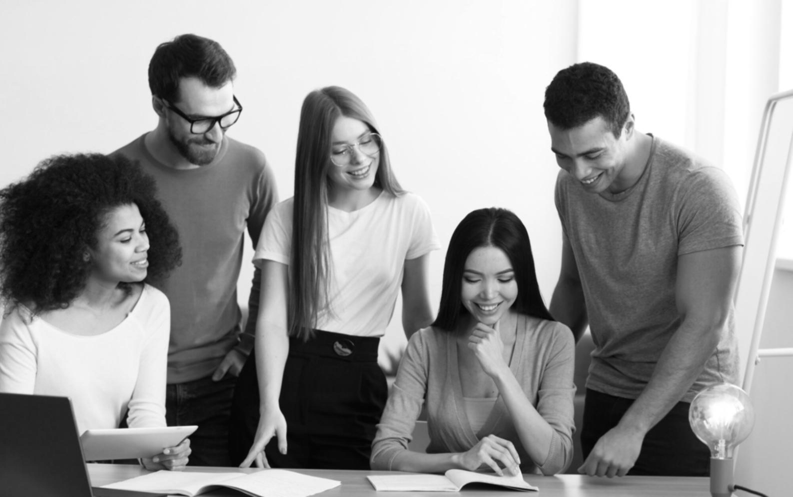Team collaboration session with financial charts and strategic planning materials on conference table